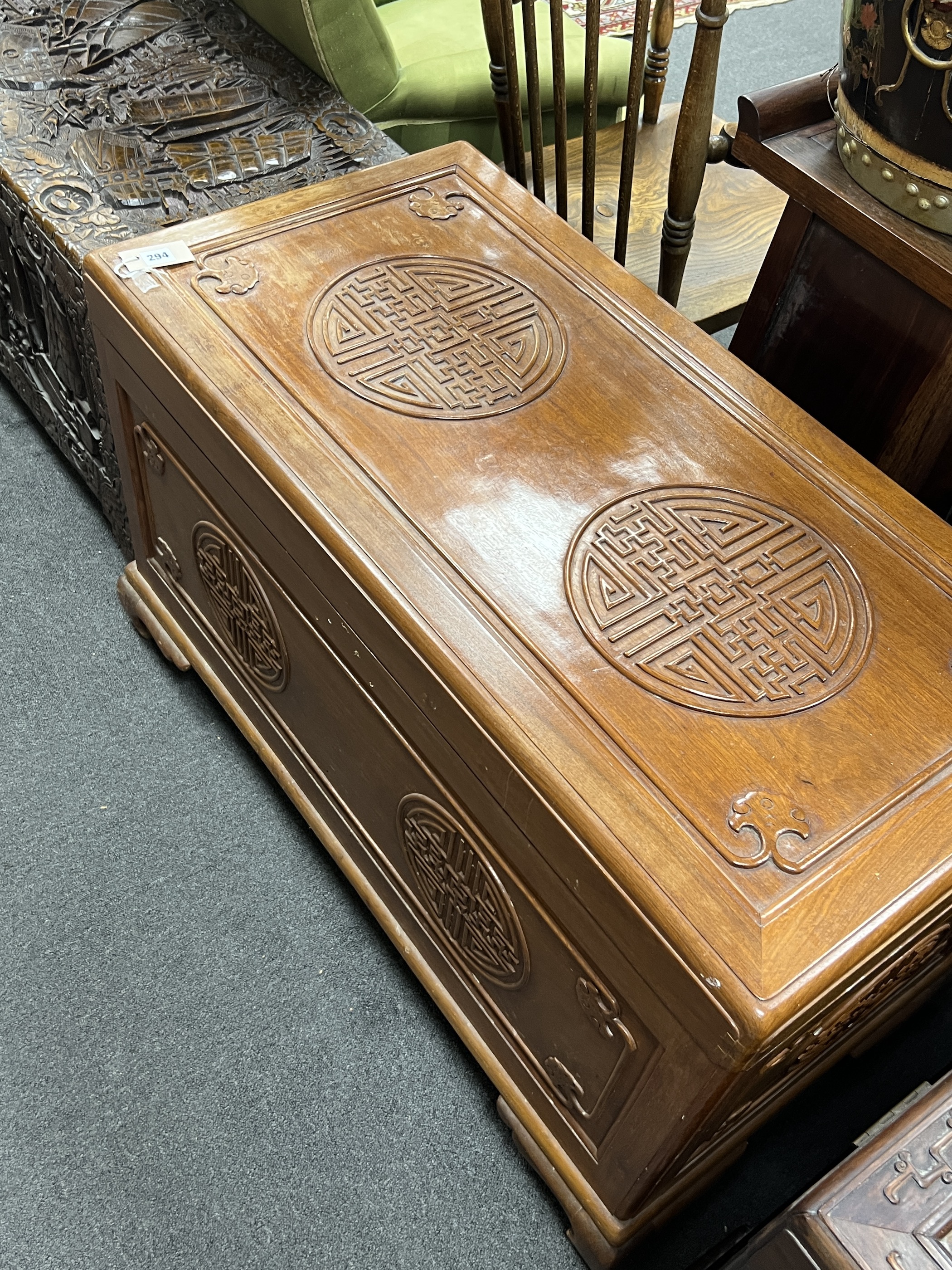 An Asian lacquered carved camphorwood trunk, length 101cm, depth 49cm, height 61cm